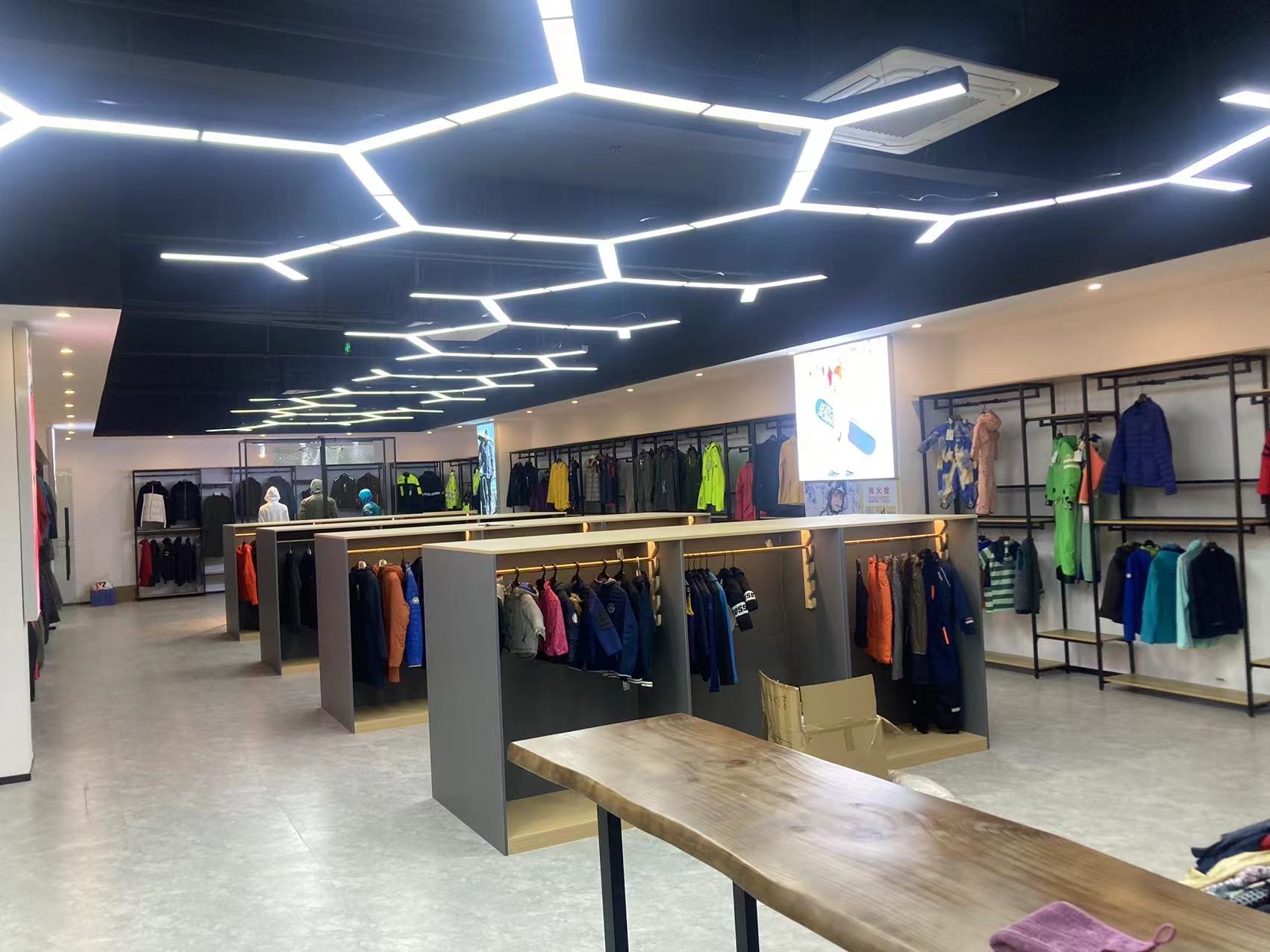 Wide apparel showroom view with racks and sample displays